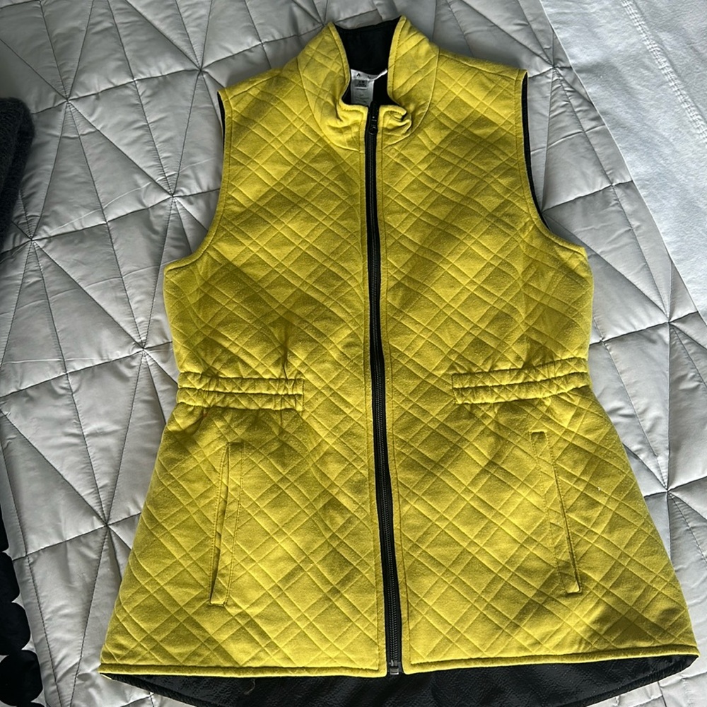Cabi chartreuse green vest with black lining and black zipper.